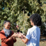 adult woman and teenage boy playing hand slap game outdoors