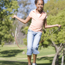 Young girl skipping with a skipping rope in the middle of a park